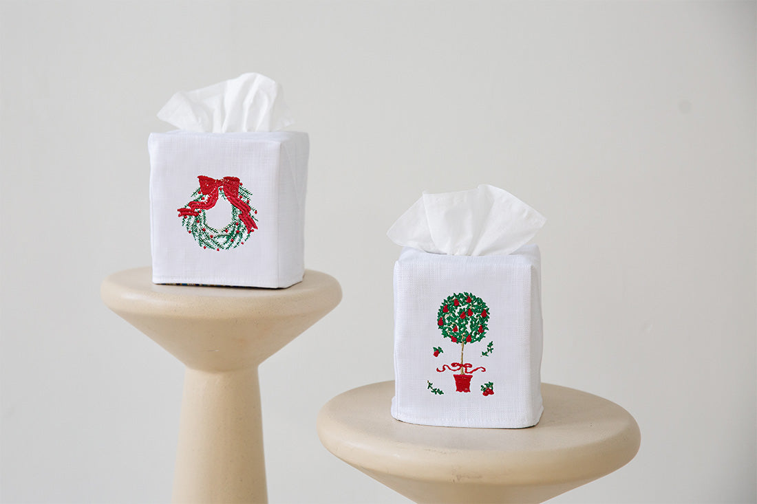 Two tissue boxes with Christmas-themed designs on a white background