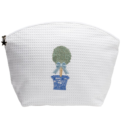 White textured pouch with decorative topiary design on a white background