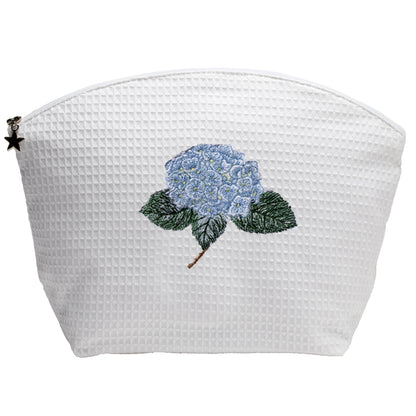 White textured pouch with blue floral design on a white background