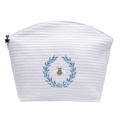 White woven pouch with embroidered design on a white background