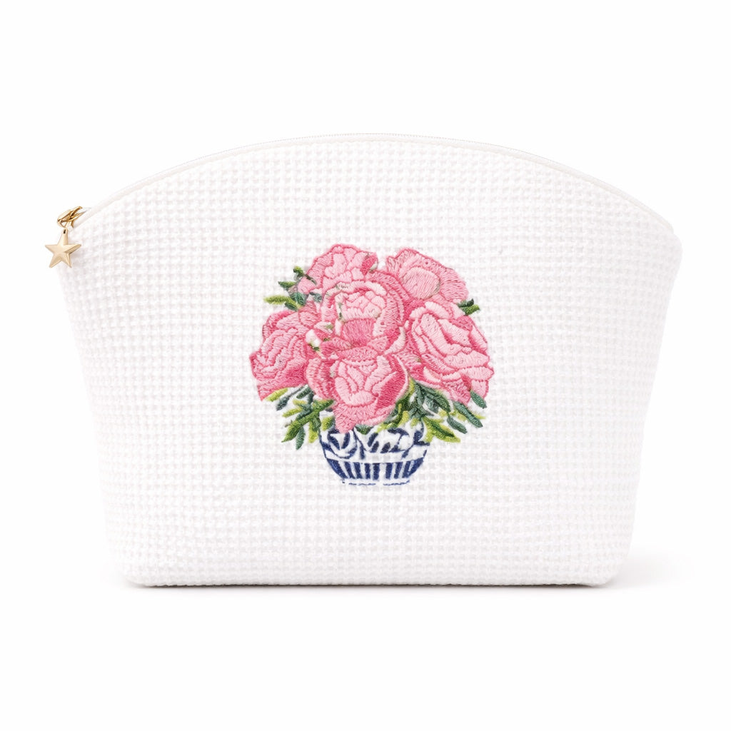 White woven pouch with pink floral design on a white background