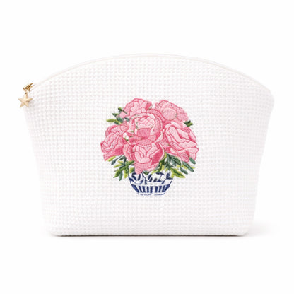 White woven pouch with pink floral design on a white background
