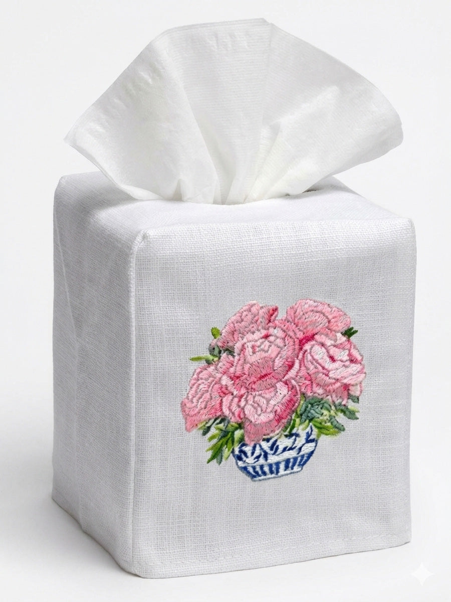 White tissue box cover with pink floral design on a white background