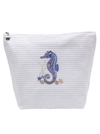 A white waffle-weave zippered pouch featuring an embroidered blue and gold seahorse design on the front, set against a plain white background.