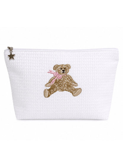 A white textured zippered pouch featuring an embroidered brown teddy bear with a pink bow on the front, complete with a small metallic star charm on the zipper pull.