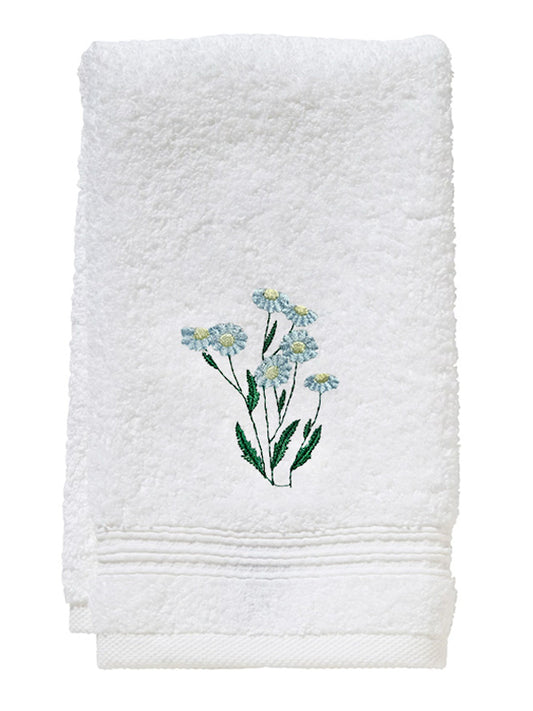 White towel with embroidered floral design on a white background
