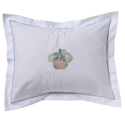 Decorative pillow with a basket of flowers design on a white background