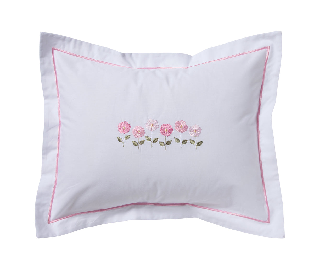 A white pillow sham featuring a delicate pink embroidered floral motif in the center and a thin pink border trim, shown against a plain white background.